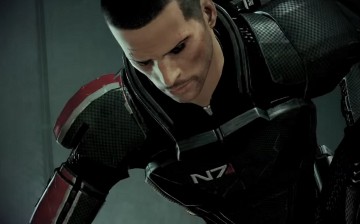 Commander Shepard kneeling down in defeat in 'Mass Effect 2.'