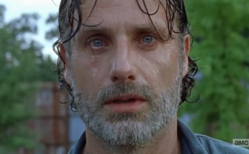 Rick sheds tears as he watches Negan and his group move out of Alexandria in 