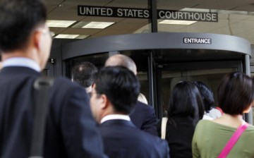 People line up to enter the Robert F. Peckham United States Courthouse Building where Apple's patent infringement case is heard.