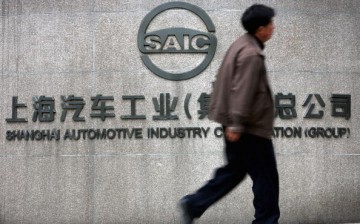 A Chinese man walks past the office building of Shanghai Automotive Industry Corp. (SAIC) on April 12, 2005, in Shanghai, China. 