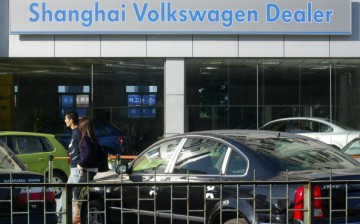 A couple walk through a Volkswagen auto dealership in Beijing.
