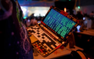 A participant poses with his laptop during the 33rd Chaos Communication Congress on its opening day on December 27, 2016 in Hamburg, Germany. 