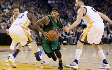  Isaiah Thomas of the Boston Celtics dribbles between Draymond Green and Andrew Bogut of the Golden State Warriors at ORACLE Arena on April 1, 2016 in Oakland, California. 