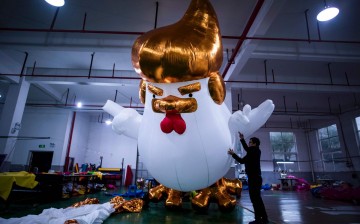 A worker inflates a giant chicken resembling Donald Trump in a factory in Jiaxing, Zhejiang Province, on Jan. 6, 2017.