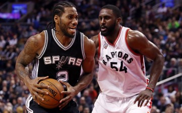 Kawhi Leonard of the San Antonio Spurs battles with Patrick Patterson of the Toronto Raptors during an NBA game at the Air Canada Centre on December 09, 2015 in Toronto, Ontario, Canada.