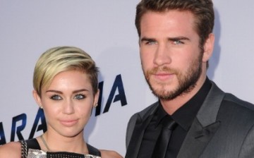 MIley Cyrus and Liam Hemsworth arrive at the 'Paranoia' - Los Angeles Premiere at DGA Theater on August 8, 2013 in Los Angeles, California. 