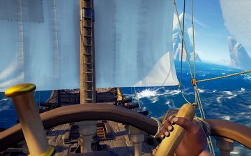 The helmsman steering a pirate ship in 'Sea of Thieves.'