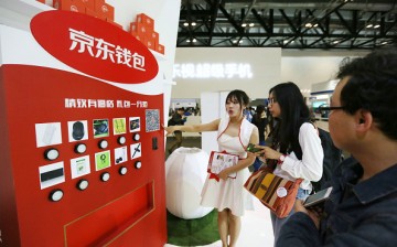 A conference participant visits one of the product booths during a GMIC event in Bejing.