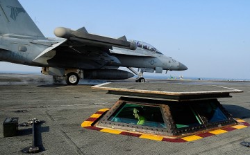 U.S. Navy crew members guide an F/A-18 Super Hornet fighter takes off from the deck of USS Aircraft Carrier Ronald Reagan on October 14, 2016 in Weat sea, South Korea. 