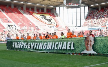  Both teams hold up a banner that reads 'Keep fighting Michael' prior to the 'Champions for charity' football match between Nowitzki All Stars and Nazionale Piloti in honor of Michael Schumacher at Opel Arena on July 27, 2016 in Mainz, Germany.