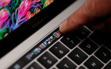 An Apple employee points to the Touch Bar on a new Apple MacBook Pro laptop during a product launch event on October 27, 2016 in Cupertino, California. 