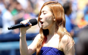 Taeyeon of Korean Pop group Girls Generation sings the Korean national anthen during Korea Day ceremonies before the game between the Cincinnati Reds and the Los Angeles Dodgers at Dodger Stadium on July 28, 2013 in Los Angeles, California.