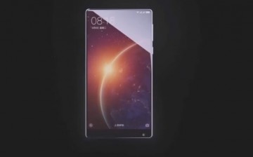 A Xiaomi smartphone is on display while showcasing its improve screen size. 