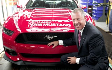 Joe Hinrichs, Ford President of the Americas, poses with the first production 2015 Ford Mustang before driving it off the assembly line at the Ford Flat Rock Assembly Plant August 28, 2014 in Flat Rock, Michigan.