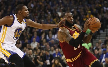 LeBron James of the Cleveland Cavaliers is guarded by Kevin Durant of the Golden State Warriors at ORACLE Arena on January 16, 2017 in Oakland, California.