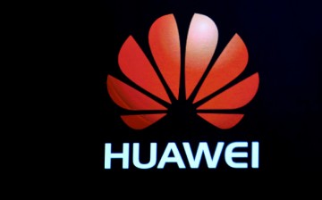 A Huawei logo is shown on a screen during a keynote address by CEO of Huawei Consumer Business Group Richard Yu at CES 2017.