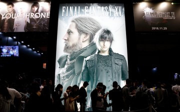 Visitors wait in line in front of an advertisement of the Final Fantasy XV video game at the Tokyo Game Show 2016 on September 15, 2016 in Chiba, Japan. 