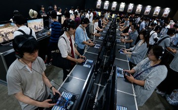 Visitors play the Final Fantasy XV video game on Sony Interactive Entertainment Inc.'s PlayStation 4 game consoles in the Square Enix Co. booth at Tokyo Game Show on September 17, 2016 in Chiba, Japan. 