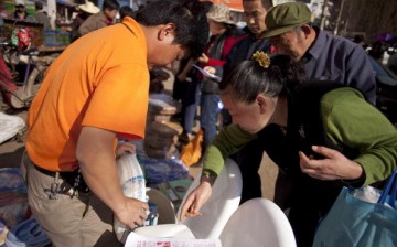 Residents of rural China shop for household items, including western style toilets, at the Shijihualiangouwu market in Chenggong, Yunnan Province.