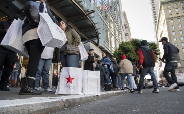 Shoppers stand outside Macy's, a U.S. mega-retailer that opened an online shop on Alibaba.com.