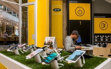 Mobile handsets and smartphones sit on display inside an MTN Group Ltd. telecommunications store in Hyde Park District of Johannesburg, South Africa.