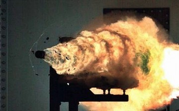 A U.S. Navy electromagnetic railgun propels a test round towards a target.            