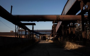 Building facilities stand in the abandoned Qingquan Steel plant which closed in 2014 and became one of several so-called 