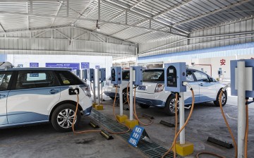 Electric taxis are plugged in to chargers at a charging station in Taiyuan, Shanxi Province.