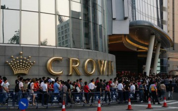 Visitors wait for the casino hotel Crown Macau official opening May 12, 2007 in Macau, China. 