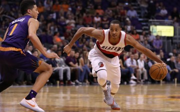 C.J. McCollum of the Portland Trail Blazers drives the ball past Devin Booker of the Phoenix Suns during the first half of the NBA game at Talking Stick Resort Arena on November 2, 2016 in Phoenix, Arizona. 