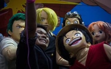 Visitor takes a selfie with cosplayers dressed as 'One Piece' characters during the Bangkok Comic Con 2016 Festival at Bitec Exhibition Centre in Bangkok, Thailand on April 29, 2016.