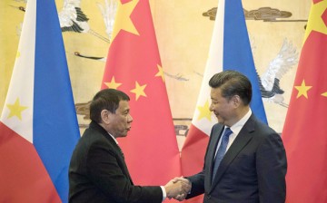 Chinese President Xi Jinping (R) shakes hands with Philippine President Rodrigo Duterte during a signing ceremony at the Great Hall of the People in Beijing last year. 