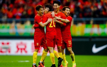 Chinese players celebrate after winning the game.