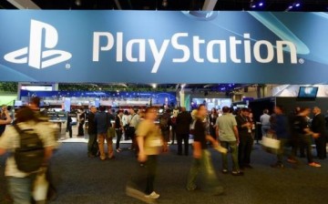 Gamers visit the PlayStation booth during a video game conference.