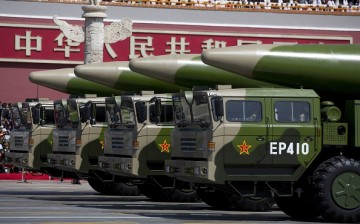 Military vehicles carrying DF-26 ballistic missiles drive past the Tiananmen Gate during a military parade on Sept. 3, 2015 in Beijing, China.