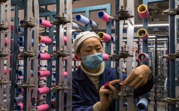 A woman checks threads in a textile factory in Nantong in China's eastern Jiangsu Province.