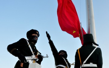 Armed police officers attend a flag-raising ceremony to celebrate new year in Greater Khingan Mountains on January 1, 2016 in Mohe, Heilongjiang Province of China.
