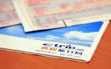Airplane tickets and a Ctrip.com envelope on a table in Beijing, China.