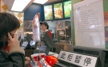 A consumer buys food at a Kentucky Fried Chicken outlet in Beijing, China.