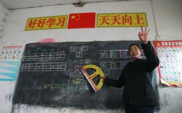 A teacher gestures as she gives a class at Xinxing School, a primary school for migrant children, Dec. 30, 2004, in Beijing, China. 