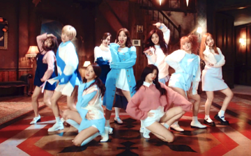 Members of the girl group, TWICE, in a still from the MV of their hit track, 