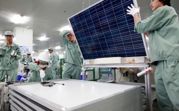 Employees assemble photovoltaic panels at Suntech Power Holdings Co.'s factory in Wuxi, Jiangsu Province.
