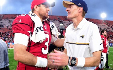 Head coach John Fassel of the Los Angeles Rams shakes hands with Carson Palmer of the Arizona Cardinals after a 44-6 Cardinals win at Los Angeles Memorial Coliseum.