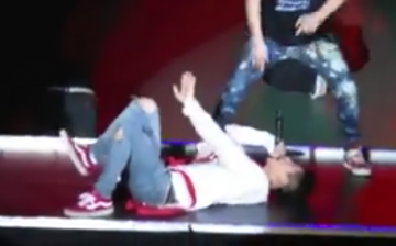 iKON's B.I lying on stage after his fall during the group's concert in Japan on Feb. 11.