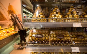 A customer shops near a display of Ferrero Rocher chocolates inside a supermarket.