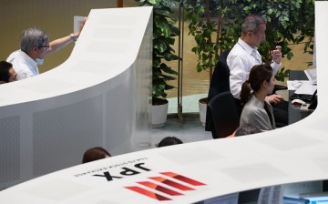Employees working at the Tokyo Stock Exchange 