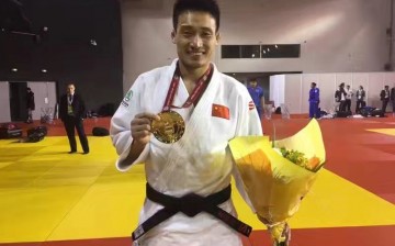 Judoka Cheng Xunzhao showing his gold medal from the Paris Grand Slam.