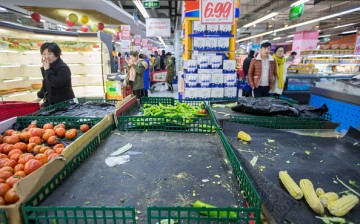Shoppers pass by almost empty shelves in a supermarket in Hangzhou, East China's Zhejiang Province.