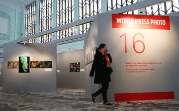 A woman attends an exhibition of award-winning photography for the 2016 World Press Photo contest.