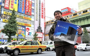 A customer holds PlayStation 4 Pro